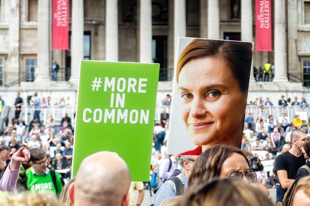 a crowd of people and a two large placards, one with an image of jo cox and one with the slogan #MoreInCommon