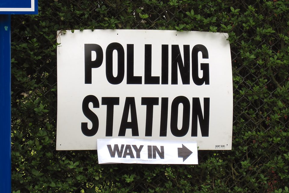 Sign saying "polling station, way in"