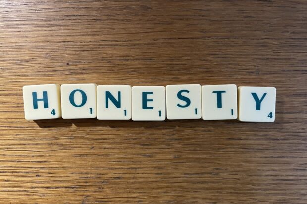 The word 'honesty' spelled with scrabble tiles